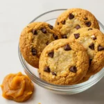 A plate of freshly baked healthy pumpkin oat cookies on a wooden table.