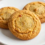 A plate of soft pumpkin oatmeal cookies with a warm, golden-brown color.