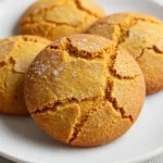A plate of soft pumpkin cookies made without sugar, garnished with a sprinkle of cinnamon.
