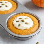A close-up of pumpkin cream cheese muffins with a swirl of cream cheese filling, inspired by Starbucks.