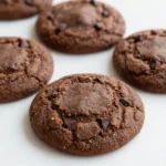 A plate of healthy no-bake chocolate peanut butter cookies on a wooden table.