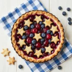 Fresh cherry and blueberry pie with a golden lattice crust on a rustic table
