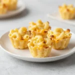 Golden oven baked mac and cheese bites served on a plate for a football Sunday snack