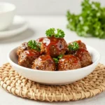 Slow cooker honey BBQ meatballs glazed in a sweet and smoky sauce, served in a crockpot